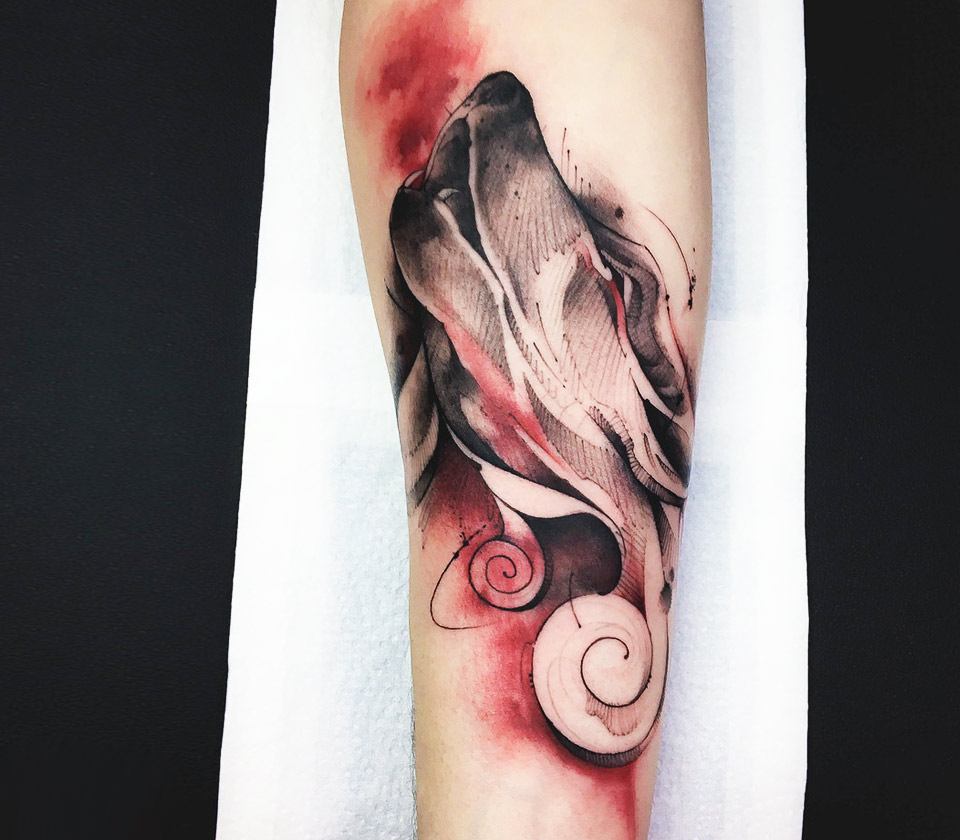 silver and red wolf tattoo