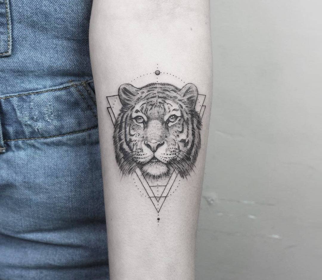 Graphic style tiger portrait tattoo located on the