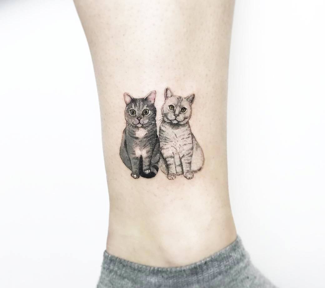 Minimalist cat tattoo on the wrist