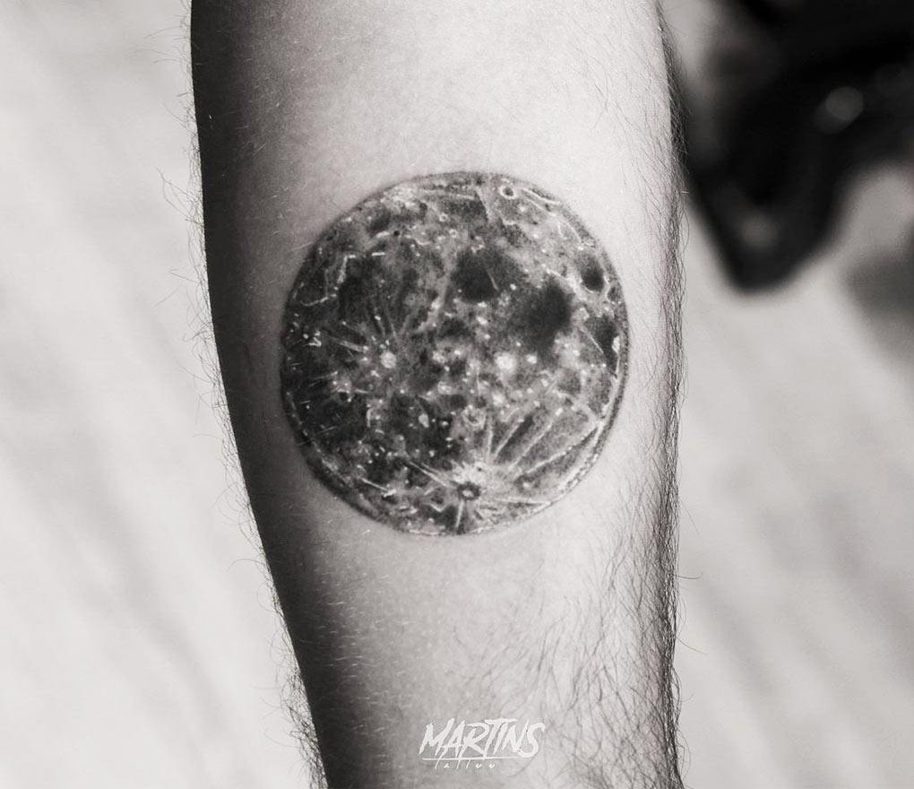 Little moon tattoo placed on the finger, minimalistic