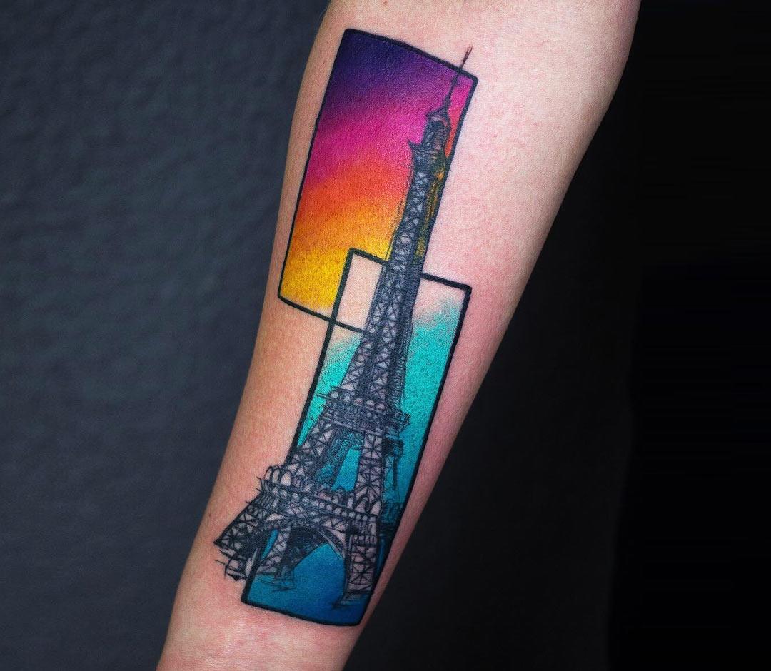 Eiffel Tower tattoo on the left upper arm.