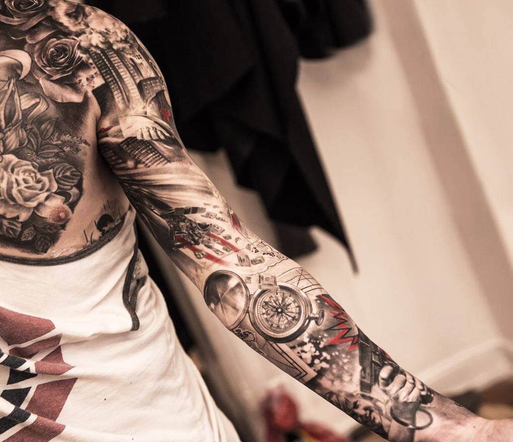 Grey and red shaded girl with rose and skull tattoo on full sleeve