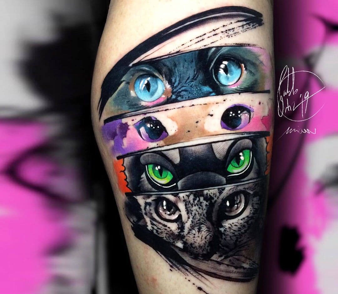 Black and grey cat portrait tattoo on the forearm.