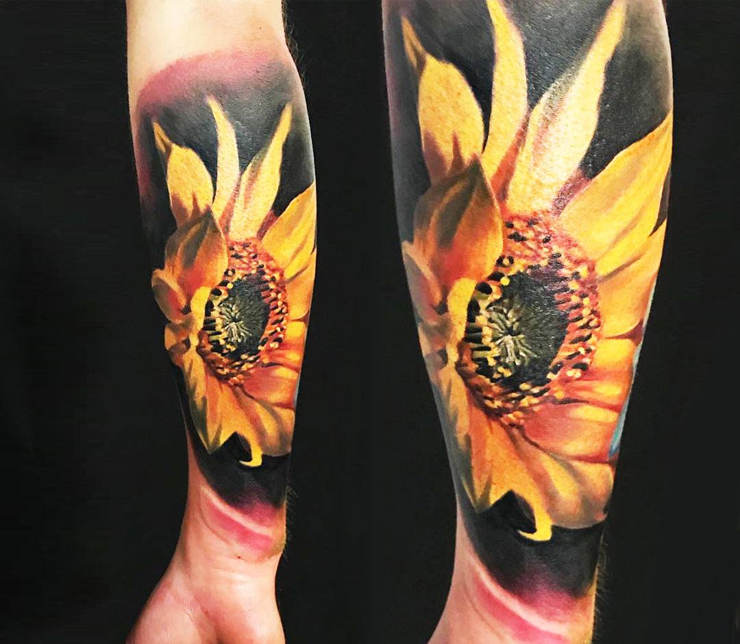 Microrealistic sunflower tattoo located on the inner