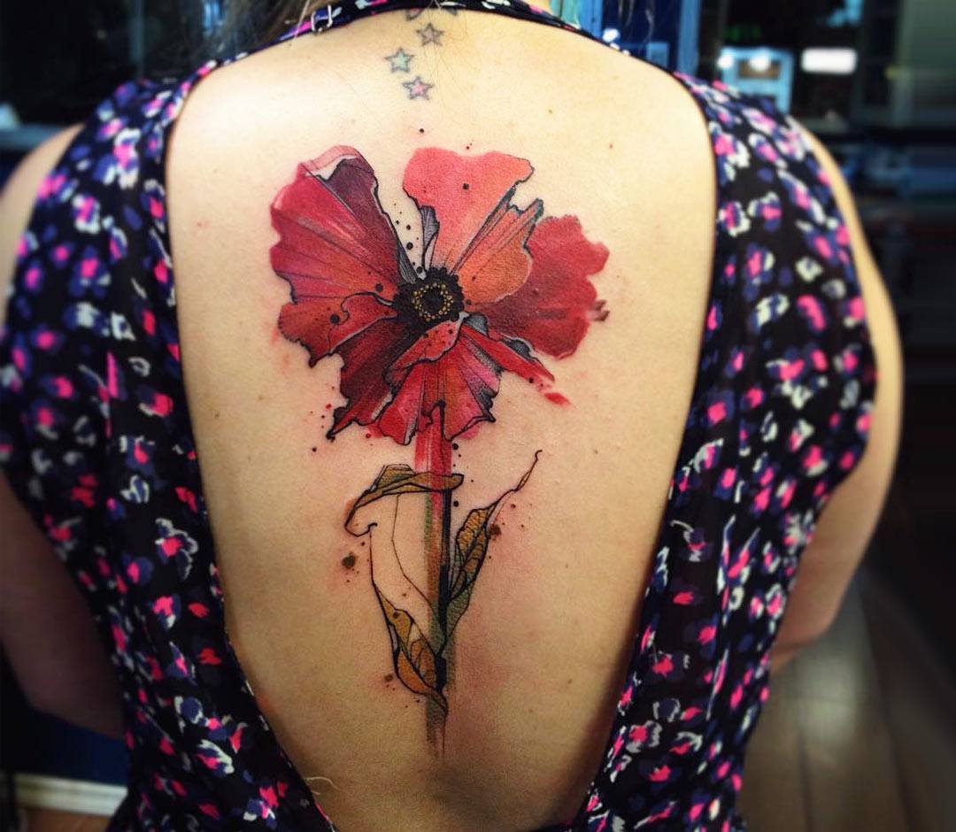 Watercolor poppy tattoos on the left shoulder blade.