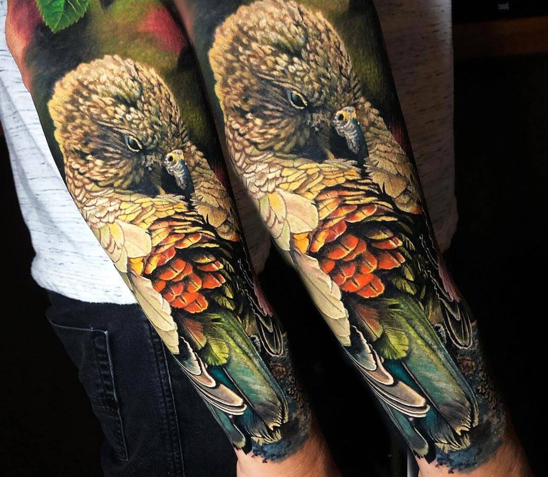 Realistic full colors Parrot tattoo art by Den Yakovlev