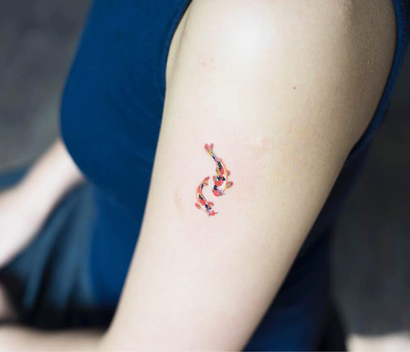 Small koi fish outline tattoo with a watercolor